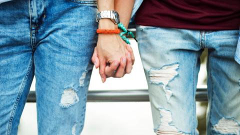 Gay couple holding hands