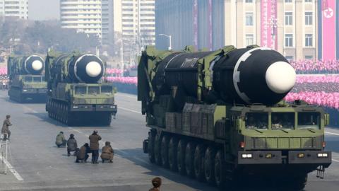 North Korean missiles on trucks.