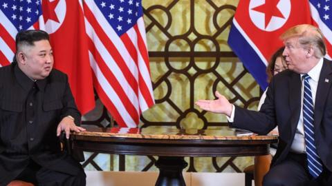 US President Donald Trump (R) speaks during a meeting with North Korea"s leader Kim Jong Un