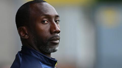 Manager Jimmy Floyd Hasselbaink on the sideline for Burton