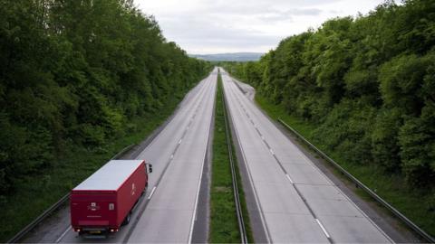 A lorry driving along a deserted road