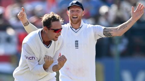 England's Tom Hartley (left) and Ben Stokes (right) celebrate a wicket