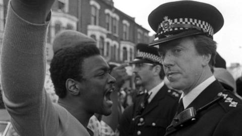 A protester confronts a police officer during the Brixton Riots