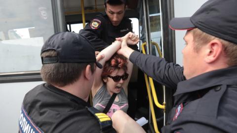 A demonstrator is detained by police during the LGBT (lesbian, gay, bisexual, and transgender) community rally in central St. Petersburg, Russia August 4, 2018