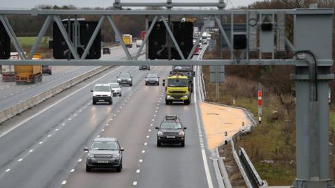 Traffic passes an emergency bay on a smart motorway section.