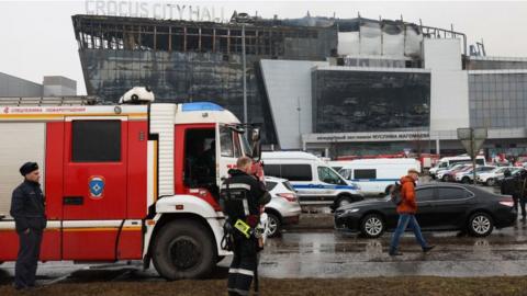 Emergency services personnel and police work at the scene of the gun attack at the Crocus City Hall concert hall in Krasnogorsk, outside Moscow, on March 23, 2024.