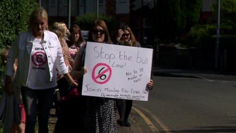 Campaigners hold protest with placard