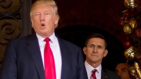 Michael Flynn watches Donald Trump speak.