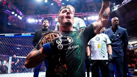 Tom Aspinall celebrates with the UFC interim heavyweight title