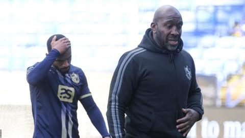 Darren Moore leads Port Vale players off the pitch after their relegation is confirmed