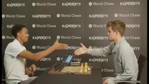 Trent Alexander-Arnold shakes the hand of chess world champion Magnus Carlsen