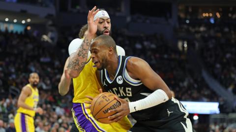Khris Middleton of the Milwaukee Bucks is defended by Anthony Davis of the Los Angeles Lakers