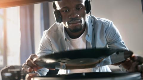 A man placing a record on a record player