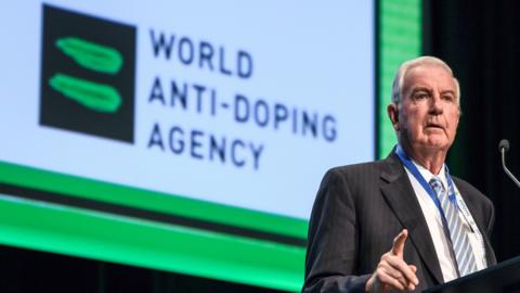 World Anti-Doping Agency president Sir Craig Reedie delivers a speech in front of the logo of the organisation