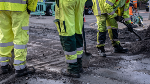 road workers wearing fluorescent yellow