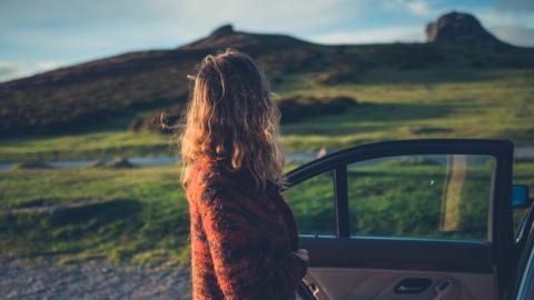 Woman looks at countryside