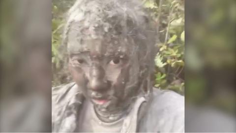 A woman covered in volcanic ash