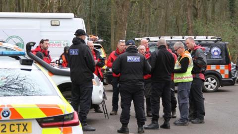 Police officers and mountain rescue team members at Sandall Beat Wood