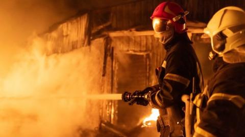 Firefighters spray water on houses in Kharkiv, north-eastern Ukraine. Photo: 10 February 2024