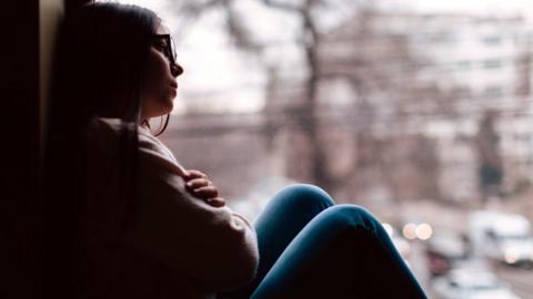 Girl looking out of a window