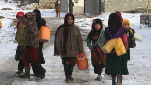 Children fetch drinking water during a cold winter day in Yaftal Sufla district of Badakhshan Province, Afghanistan, 18 January 2023