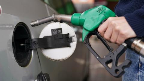 Close up of man putting petrol in car