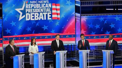 Image shows the candidates on stage in Miami