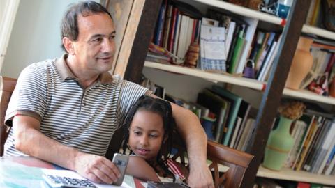 Domenico Lucano with Ethiopian child in Riace in 2011