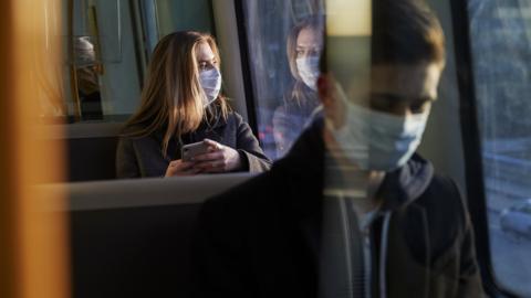 Young people on bus with masks