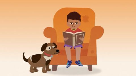 Cartoon Character Dylan sat on a chair reading alongside his dog, Lola