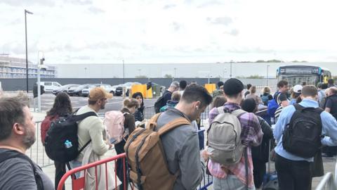 Passengers wait for busses at Luton Dart