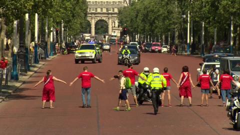 Greenpeace protesters blocking motorcade