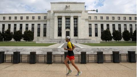 A jogger runs past the Federal Reserve building in Washington, DC, U.S., August 22, 2018.