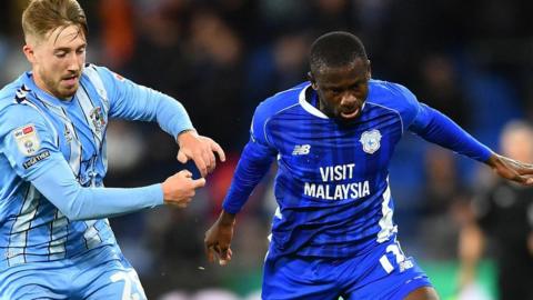 Jamilu Collins (R) of Cardiff City is challenged by Josh Eccles of Coventry City