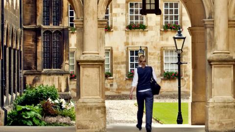 Student walking around a campus at Cambridge University