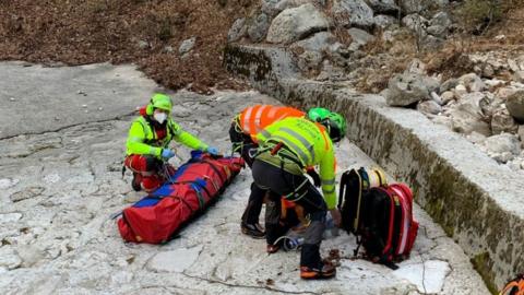 Rescuers with injured man