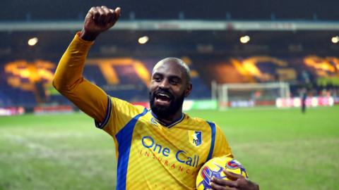 Mansfield's Hiram Boateng celebrates his hat-trick against Harrogate