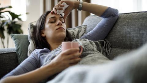 woman sick on sofa