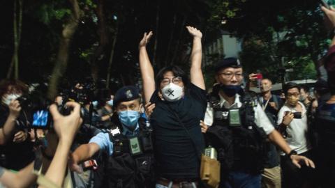 An activist is arrested in Hong Kong on Saturday