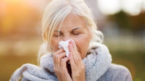 Woman using a tissue