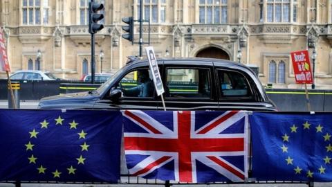 Union and EU flags outside the Houses of Parliament