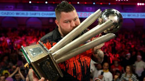 Michael Smith kisses PDC World Championship trophy