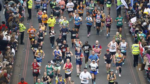 Runners cross Tower Bridge during the London Marathon on 21 April