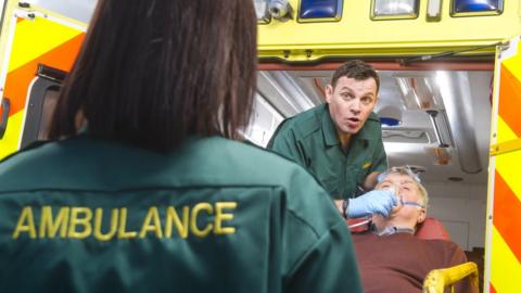 Patient being taken into A&E from an ambulance