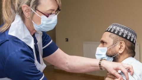 Nurse gives jab to Muslim man