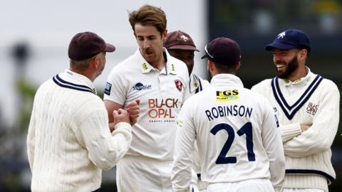 Matt Quinn (2nd L) of Kent is congratulated after bowling Glamorgan's David Lloyd