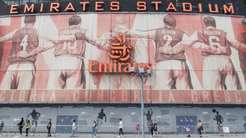 Emirates Stadium with a queue for coronavirus vaccinations