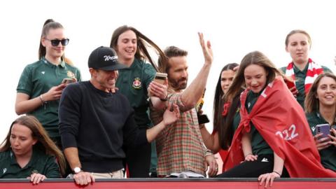 Wrexham players with club co-chairmen Rob McElhenney and Ryan Reynolds on the open top bus parade