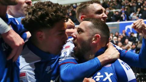 Conor Chaplin celebrates with Ipswich teammates