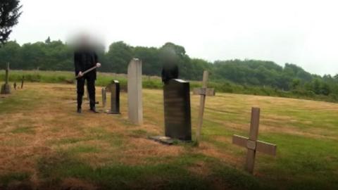 The headstone being destroyed